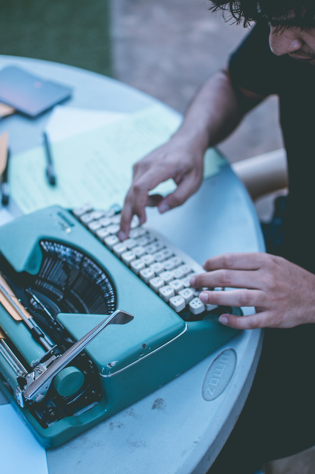 writer typing on typewriter